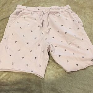 Pink shorts with sharks and palm trees